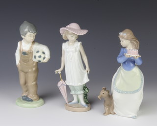 A Nao figure of a girl with birthday cake 18cm, do. with a parasol 19cm and a boy with a football 19cm 