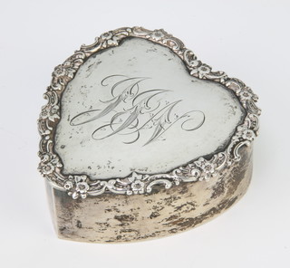 A silver heart shaped trinket ring box with scrolled border and engraved  monogram 8cm 