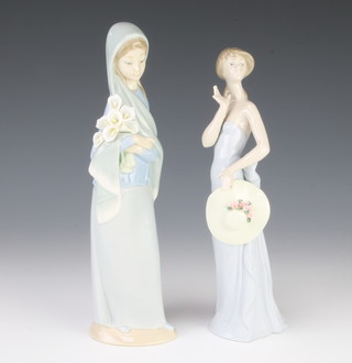A Lladro figure of a lady holding her hat 5599 21cm and a lady holding flowers 23cm 