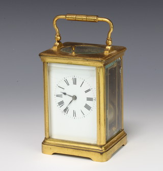 A 19th Century French 8 day repeating carriage timepiece with enamelled dial and Roman numerals, contained in a gilt metal case  12cm x 8cm x 8cm 