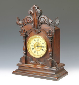 United Clock Company Ltd, a striking mantel clock with paper dial and Roman numerals, contained in a carved mahogany case 