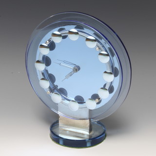 An Art Deco blue tinted plate glass timepiece with chromed roundels contained in a circular blue glass stand