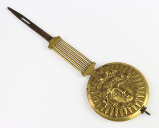 A Regency gilt metal grid iron pendulum, the bob cast a classical mask, possibly form a portico or lyre clock 