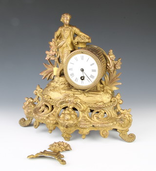 A 19th Century French timepiece with enamelled dial and Roman numerals contained in a gilt painted spelter case supported by a figure of a standing gardener 