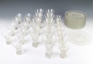 A suite of table glassware by Andre Hunebelle comprising 7 tots, 9 water glasses, 9 wine glasses together with 12 side plates, the frosted decoration with tapered leaves 