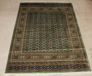 A green ground Belgian cotton Bokhara style carpet with numerous octagons to the centre 280cm x 200cm 