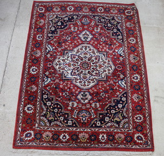 A red and blue ground Persian Bakhtiari carpet with central medallion 343cm x 254cm 