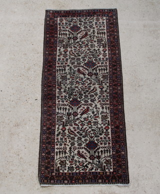 A Persian Malayer runner, white ground, with stylised trees and birds within a multi row border, 191cm x 81cm 