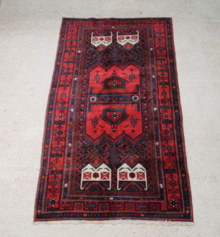 A blue and red ground Persian Koliai carpet having a shaped medallion within a multi row border 267cm x 150cm 