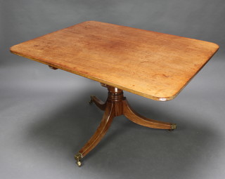 A Regency rectangular mahogany breakfast table raised on a turned gun barrel and tripod base ending in brass caps and casters 72cm h x 91cm w  x 122cm d
