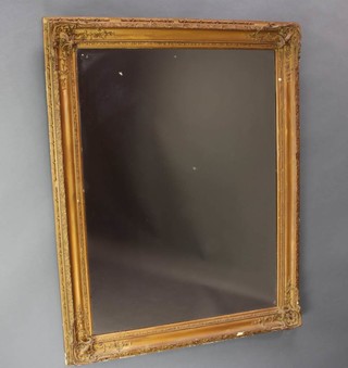 A Victorian rectangular plate mirror contained in a decorative gilt frame 120cm x 91cm