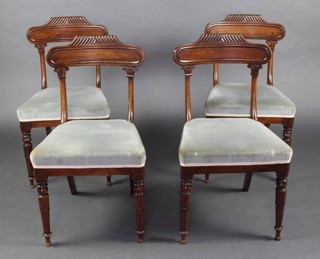 A set of 4 William IV mahogany bar back dining chairs with over stuffed seats, raised on turned supports 
