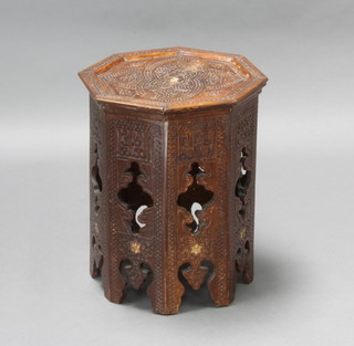 A Moorish octagonal carved hardwood table raised on pierced panelled supports 40cm h x 37cm w x 38cm d 
