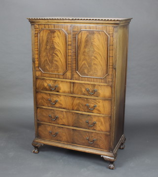 A Chippendale style mahogany tall boy, the upper section with moulded cornice, the interior fitted 2 trays enclosed by a panelled door, the base fitted 2 short and 2 long drawers raised on cabriole ball and claw supports 60cm x 98cm x 55cm 
