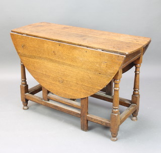An 18th Century oak oval drop flap gateleg dining table raised on turned supports 73cm h x 114cm w x 42cm d 