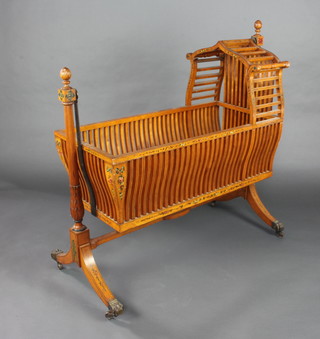 An Edwardian Sheraton style painted satinwood cradle, raised on a turned fluted column 110cm h x 108cm l x 47cm w