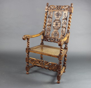 A Victorian, 17th Century style carved oak open arm chair with pierced and splat back and woven cane seat, raised on turned and block supports with H framed stretcher  