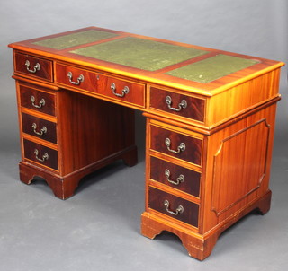 A Georgian style yew kneehole pedestal desk with green inset writing surface above 1 long and 8 short drawers, raised on bracket feet 77cm h x 122cm w x 61cm d  
