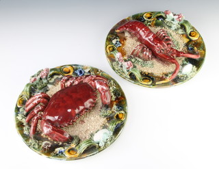 A pair of 19th Century Continental Majolica plaques decorated with a lobster and crab 25cm diam. 
