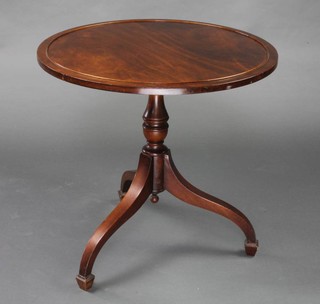 A Georgian style circular mahogany occasional table, raised on pillar and tripod supports 57cm h x 60cm diam. 