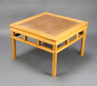 A square Chinese light hardwood coffee table with rattan centre 51cm h x 56cm w x 56cm d 