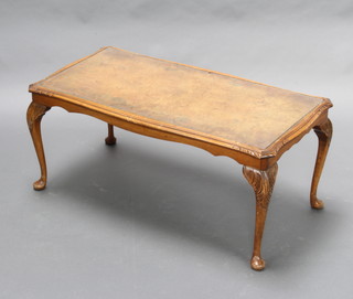 A Queen Anne style rectangular figured walnut coffee table raised on cabriole supports 43cm h x 95cm w x 49cm d 
