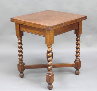 A 1930's oak draw leaf dining table raised on spiral turned supports with X framed stretcher 75cm x 66cm x  61cm 