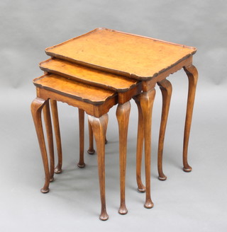A nest of 3 figured walnut Queen Anne style interfitting coffee tables raised on cabriole supports 57cm x 50cm w x 39cm d  