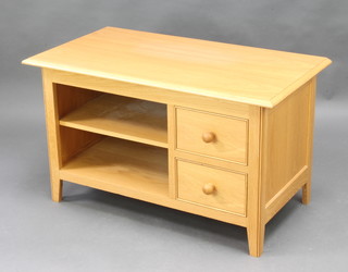 A Shaker style light oak audio cabinet with recess flanked by 2 short drawers, raised on tapered supports 56cm h x 95cm w x 50cm d 