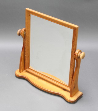 A rectangular plate dressing table mirror contained in a pine swing frame 58cm h x 56cm w x 14cm d 