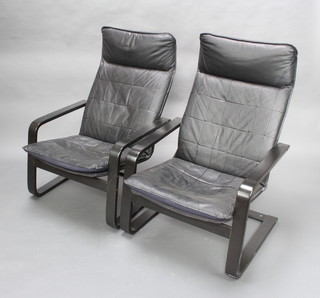 A pair of ebonised cantilever chairs upholstered in black leather 
