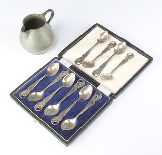 A Tudric planished pewter cream jug, the base marked Tudric 01217 Made in England Solkets together with a set of 10 silver plated Art nouveau teaspoons marked CG.H.IMA ALP