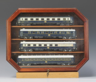 Four Rivarossi HO gauge model Orient Express pullman carriages comprising restaurant carriage, first class compartment, bar carriage and sleeping car, contained in a mahogany presentation case 