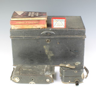 A Pathe-baby cine camera, a Kodak folding camera (f) and 3 volumes C H Bothamley "Manual of Photography" Percy W Harris "Home Processing" and Harold A Abbott "Motion Pictures with The Baby Cine", all contained in a metal deed box 