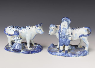 A late 19th Century Delft group of a boy beside a cow 13cm, a do. of a milkmaid milking a cow 8cm 