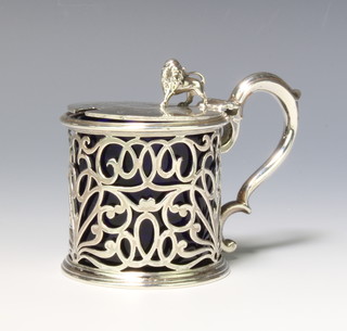 A Victorian silver mustard with lion finial, S scroll handle and pierced body with a blue glass liner, London 1844, maker Charles Thomas Fox & George Fox 158 grams