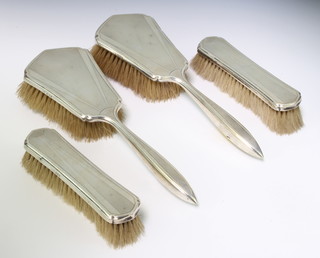 An Art Deco silver dressing table set comprising 2 hair brushes and 2 clothes brushes London 1932 