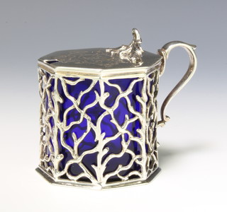 A Victorian silver mustard with scroll finial and S scroll handle with pierced rustic body and blue glass liner, London 1846 maker Charles Thomas Fox & George Fox 190 grams