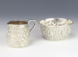 A repousse silver cream jug and sugar bowl with floral decoration 139 grams 