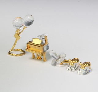 Four Swarovski Crystal Classics - grand piano 3cm, dummy 3cm, tied balloons 5cm and a pair of baby shoes 2cm, boxed 