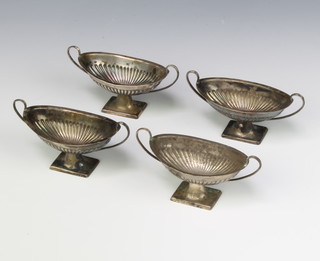A set of 4 Victorian repousse silver boat shaped table salts on square bases, Sheffield 1899, 32 grams 