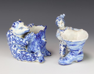 A Delft vase in the form of a bear sitting astride a trunk 11cm, a do. of a child beside a giant boot 12cm 