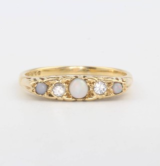 An 18ct yellow gold opal and diamond ring size P 1/2 