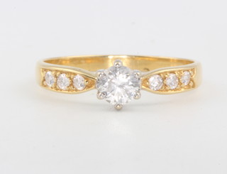 A yellow gold single stone diamond ring approx. 0.75ct the shoulders with 3 brilliant cut diamonds size T