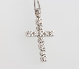 A white gold diamond set cross, 33mm x 20mm, on an 18ct gold chain 40cm 