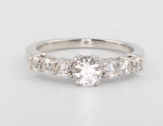 An 18ct white gold diamond ring, the centre stone approx 0.5ct flanked by 3 brilliant cut diamonds size L 