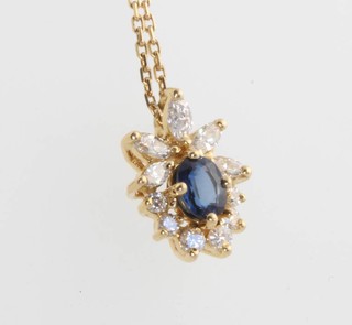 A 18ct yellow gold sapphire and diamond pendant on a yellow gold chain 40cm 