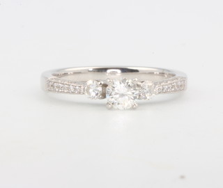 An 18ct white gold single stone diamond ring with diamond set shoulders size N 1/2