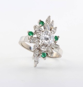An 18ct white gold diamond and emerald floral ring the centre stone approx. 0.65ct surrounded by brilliant and baguette cut diamonds and brilliant cut emeralds size L 