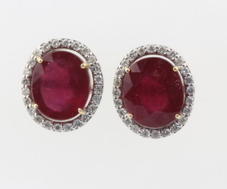 A pair of 18ct white gold ruby and diamond cluster ear studs, the rubies 4.63ct, the diamonds 0.27ct 